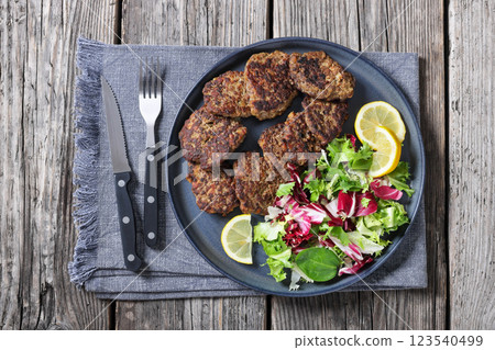 pork liver patties with fresh salad and lemon 123540499