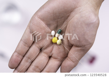 Hand holding medicine and glass of water 123540528