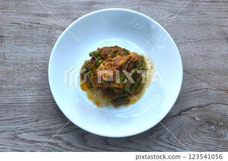 spicy stir fried slice yard long bean with fat pork and lemon grass in curry sauce on plate 123541056