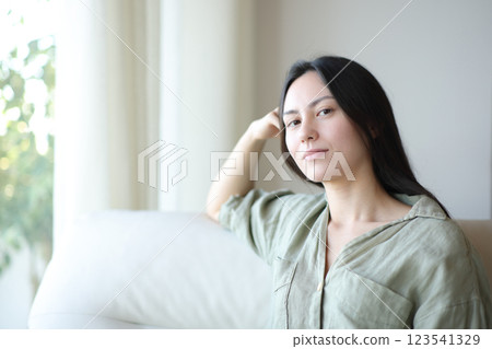 Serious asian woman posing at home looking at you 123541329