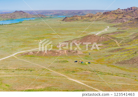 An off-road tourist trip to the mountains of Almaty. picnic on four-wheel drive cars in the steppe 123541463