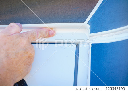 Applying silicon on caravan body 123542193