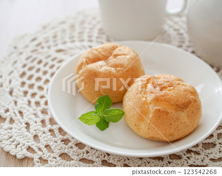 Two cream puffs on a white plate Two cream puffs on a white plate 123542268