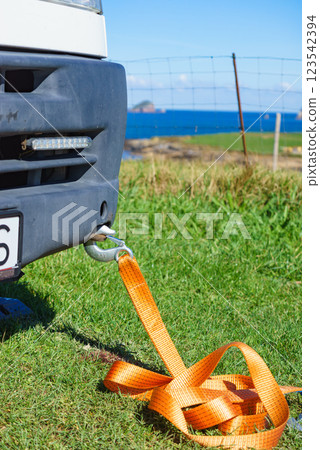 Tow hook with orange strap on car. Towing equipment. Tow hook with orange strap on car. Towing equipment. 123542394