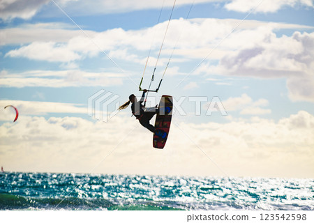 Kite surfer riding waves. Kiteboarding sport. 123542598