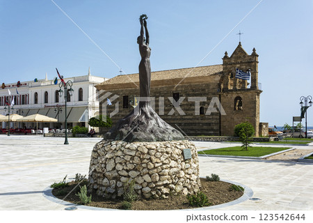 Greece, Zakynthos island-June 17, 2016: statue of Glory on the background of the Church of St. Nicholas Mola Greece, Zakynthos island-June 17, 2016: statue of Glory on the background of the Church of St. Nicholas Mola 123542644