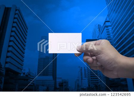 Man hand holding blank white business name card in fingers 123542695