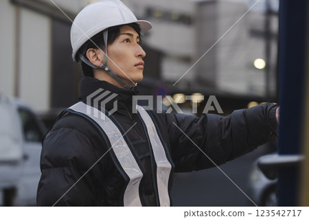A man in work clothes drinking canned coffee A man in work clothes drinking canned coffee 123542717