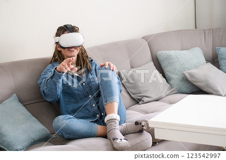 Woman Wearing VR Glasses in Living Room. Woman Wearing VR Glasses in Living Room. 123542997
