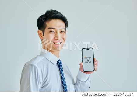 A young man in his 20s with a smartphone New NISA & iDeCo 123543134