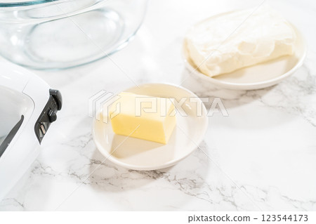 Preparing cream cheese frosting to ice the delicious pumpkin bundt cake. 123544173
