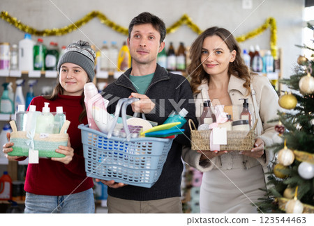 Cheerful family shopping for self-care and hygiene products in decorated store Cheerful family shopping for self-care and hygiene products in decorated store 123544463