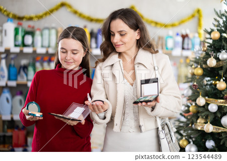 On New Year Eve, woman with teen daughter choose cosmetic pallet for allergy sufferers 123544489