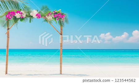 Wedding arch decorated with orchids and palm leaves stands on tropical beach 123544562