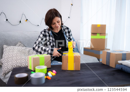 Girl Packing Box For Shipping Homemade Products Selling Online 123544594