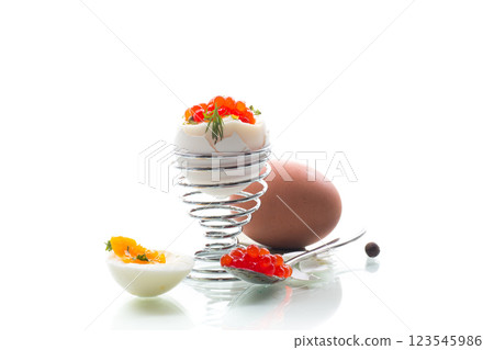 Delicacy with red caviar and boiled egg, isolated on white background Delicacy with red caviar and boiled egg, isolated on white background 123545986