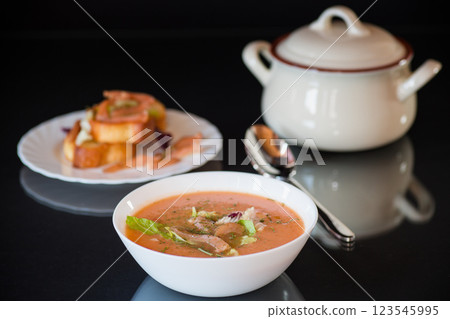Thick and creamy cream soup of trout in a plate, isolated on black background 123545995