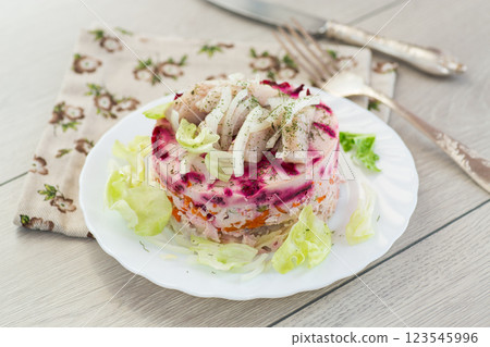Delicious beetroot salad with herring on a served table Delicious beetroot salad with herring on a served table 123545996