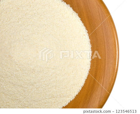 Raw semolina flour in a wooden bowl filling the frame Raw semolina flour in a wooden bowl filling the frame 123546513