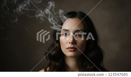 Mysterious woman with smoky aura in low light portrait Mysterious woman with smoky aura in low light portrait 123547085
