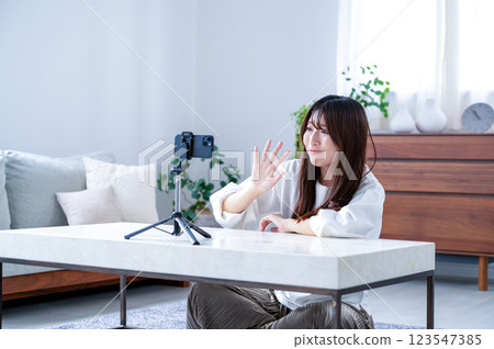 Smiling young woman taking a video Smiling young woman taking a video 123547385