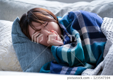 A young woman who is sick and falls asleep 123547394