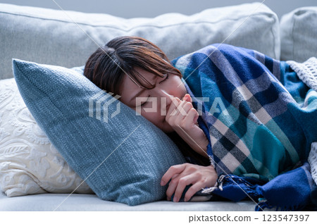 A young woman who is sick and falls asleep A young woman who is sick and falls asleep 123547397