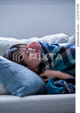 A young woman who is sick and falls asleep 123547398