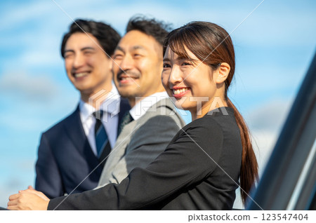 Three smiling businessmen standing side by side 123547404
