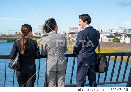 Three businessmen talking side by side Three businessmen talking side by side 123547406