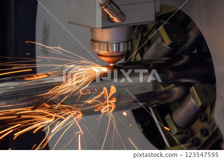 Close up scene the fiber laser cutting machine cut the stainless steel tube and sparkling light. 123547595