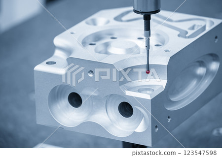 Close up scene the CMM probe measuring the aluminum automotive parts in the light blue scene. Close up scene the CMM probe measuring the aluminum automotive parts in the light blue scene. 123547598