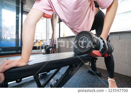 Woman doing muscle training at the gym Woman doing muscle training at the gym 123547700