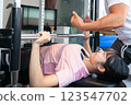 Woman doing muscle training at the gym 123547702