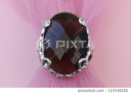 Statement ring for women on a pink background, fine jewelry concept, promotional photo for an online vintage and handmade jewelry store Statement ring for women on a pink background, fine jewelry concept, promotional photo for an online vintage and handmade jewelry store 123548288