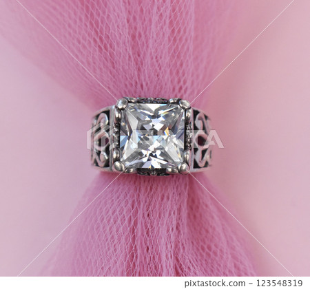 Statement ring for women on a pink background, fine jewelry concept, promotional photo for an online vintage and handmade jewelry store Statement ring for women on a pink background, fine jewelry concept, promotional photo for an online vintage and handmade jewelry store 123548319