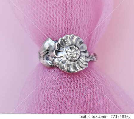Statement ring for women on a pink background, fine jewelry concept,  promotional photo for an online vintage and handmade jewelry store 123548382