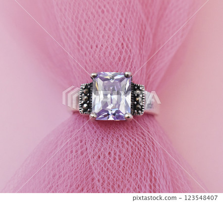 Statement ring for women on a pink background, fine jewelry concept, promotional photo for an online vintage and handmade jewelry store Statement ring for women on a pink background, fine jewelry concept, promotional photo for an online vintage and handmade jewelry store 123548407
