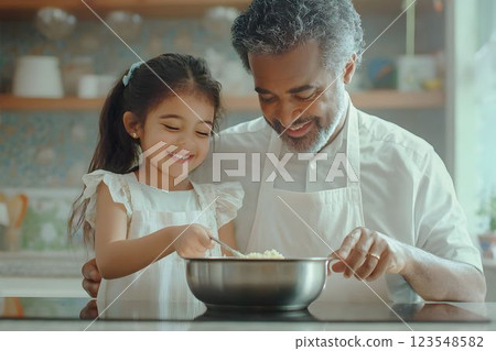 Father and daughter bonding while preparing a colorful dish in their home kitchen. Father teaches his young daughter to cook. They mix ingredients together in a bowl 123548582