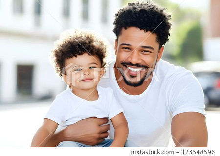 Father and son enjoying a joyful moment outdoors on a sunny day in a suburban neighborhood 123548596
