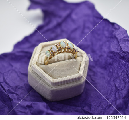 Statement ring for women on a purple background, fine jewelry concept, promotional photo for an online vintage and handmade jewelry store Statement ring for women on a purple background, fine jewelry concept, promotional photo for an online vintage and handmade jewelry store 123548614