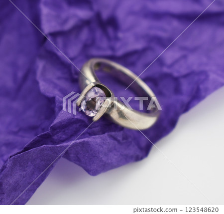 Statement ring for women on a purple background, fine jewelry concept, promotional photo for an online vintage and handmade jewelry store Statement ring for women on a purple background, fine jewelry concept, promotional photo for an online vintage and handmade jewelry store 123548620