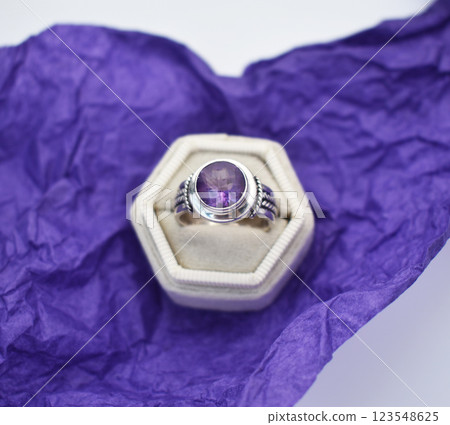 Statement ring for women on a purple background, fine jewelry concept, promotional photo for an online vintage and handmade jewelry store Statement ring for women on a purple background, fine jewelry concept, promotional photo for an online vintage and handmade jewelry store 123548625