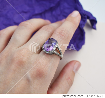Statement ring for women on a purple background, fine jewelry concept,  promotional photo for an online vintage and handmade jewelry store 123548639