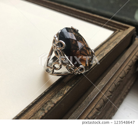 Statement ring for women on a white background, fine jewelry concept,  promotional photo for an online vintage and handmade jewelry store 123548647