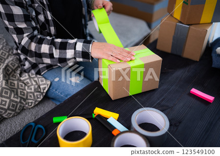 Girl Packing Cardboard Box At Home 123549100