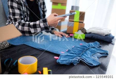 Girl Taking Photo Her Sundress To Sell It Online 123549101