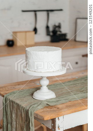 fake white cake on wooden table. plastic cake for children photo shoots fake white cake on wooden table. plastic cake for children photo shoots 123549201