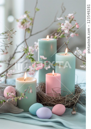 Easter interior decoration with burning candles, Easter eggs, hay and spring flowers 123549281