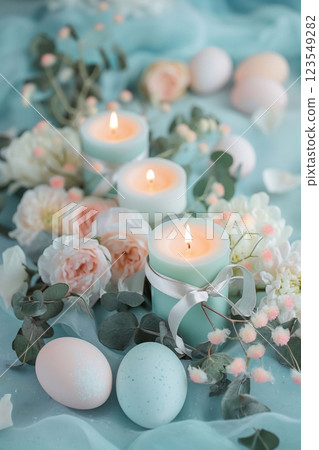 Easter interior decoration with burning candles, Easter eggs, hay and spring flowers Easter interior decoration with burning candles, Easter eggs, hay and spring flowers 123549282